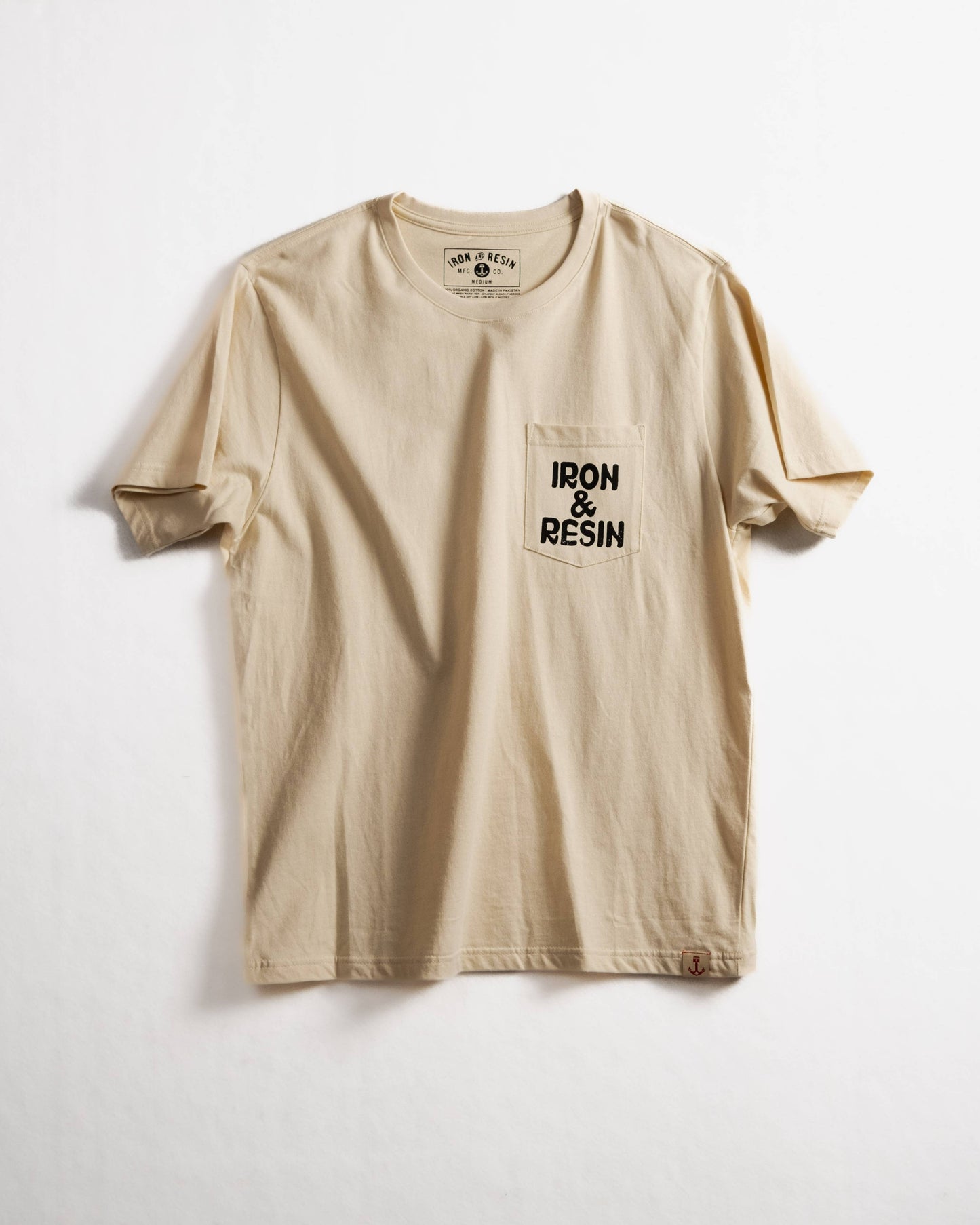 Beige t-shirt with 'IRON & RESIN' logo on a white background