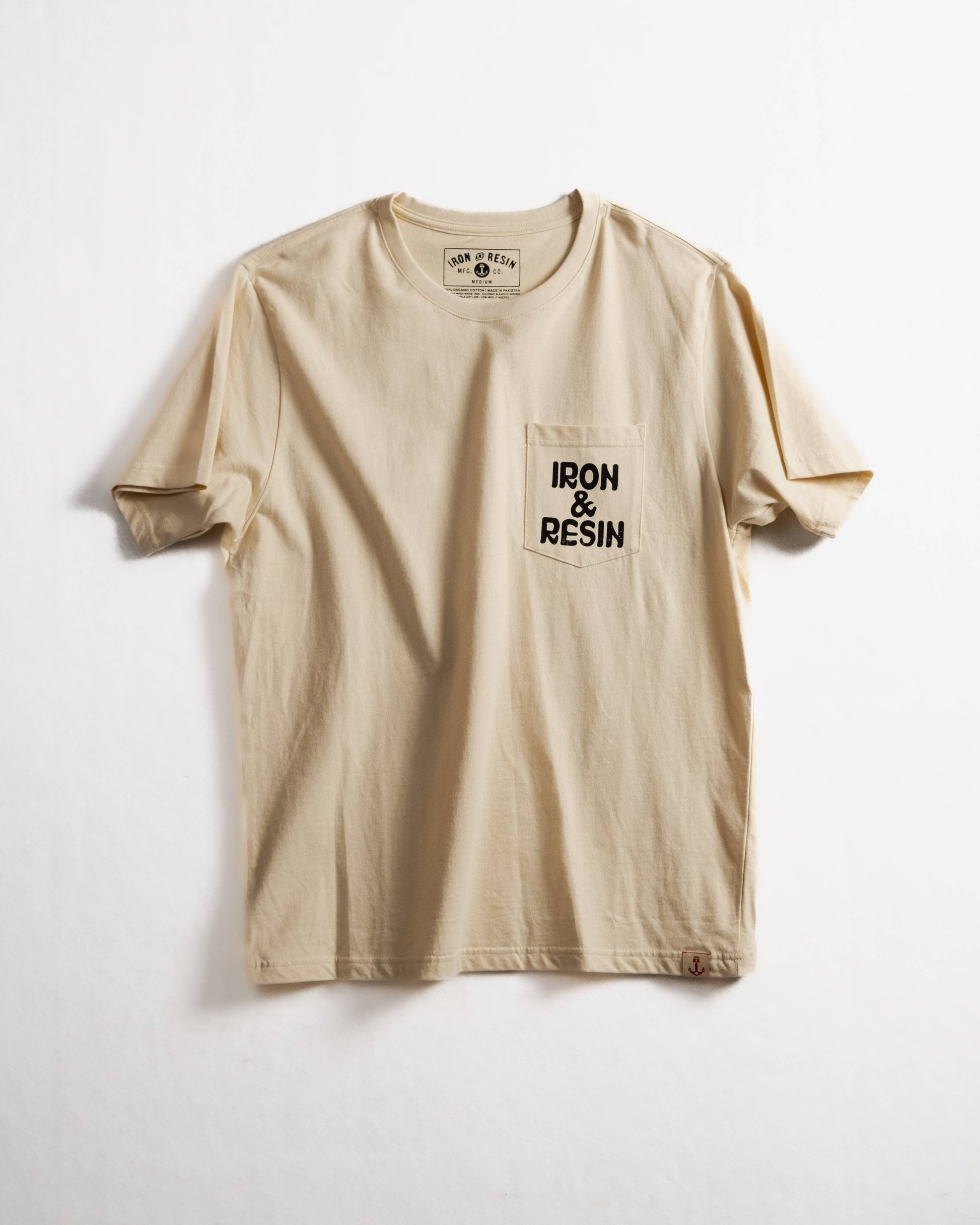 Beige t-shirt with 'IRON & RESIN' logo on a white background