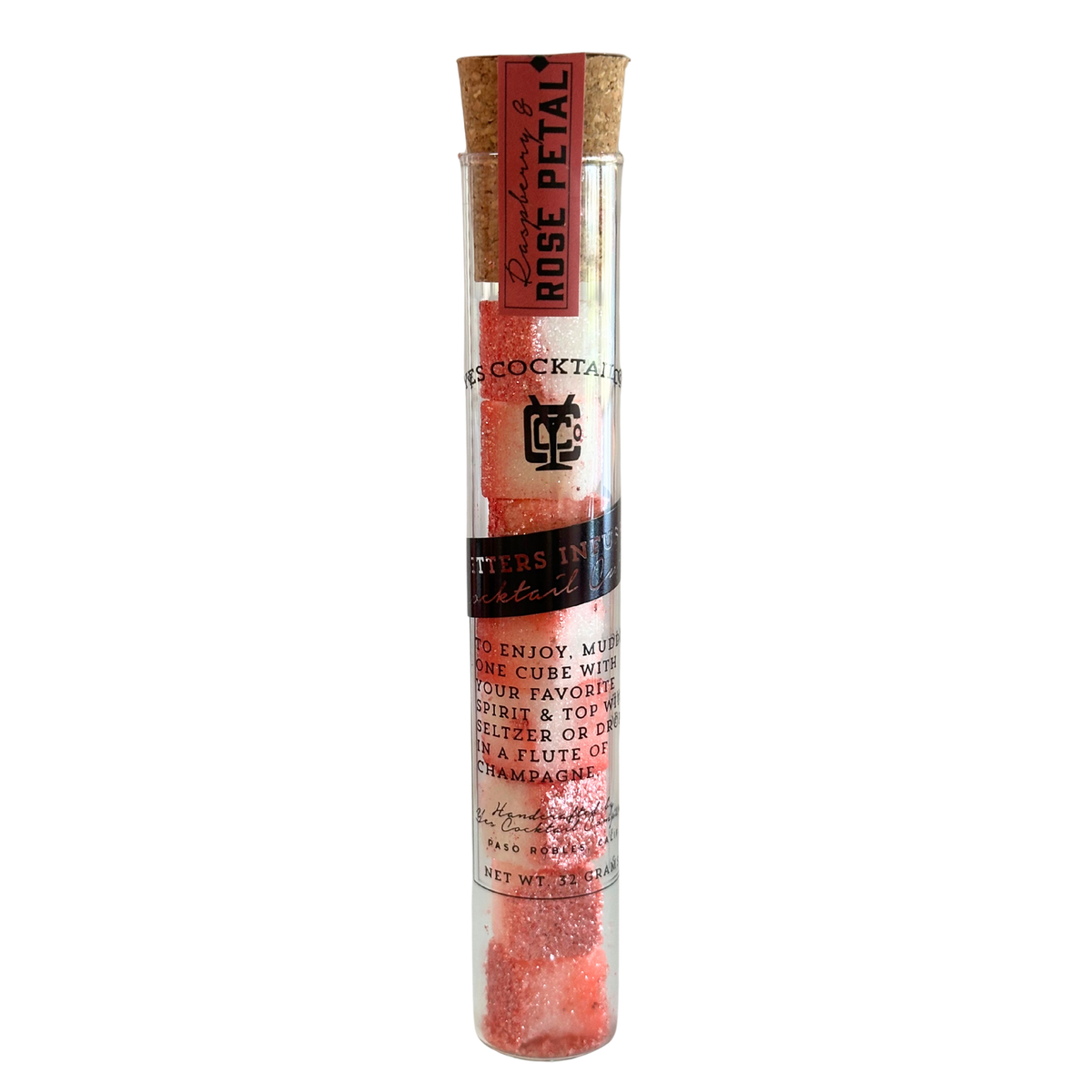 Cocktail rose petal mix in a glass tube with cork lid on a white background