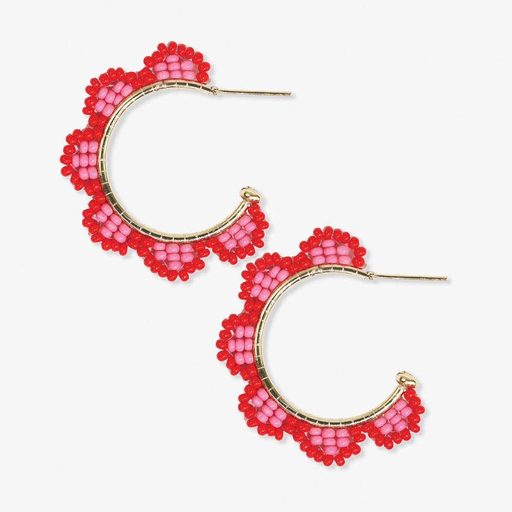 Pair of pink beaded hoop earrings on a white background