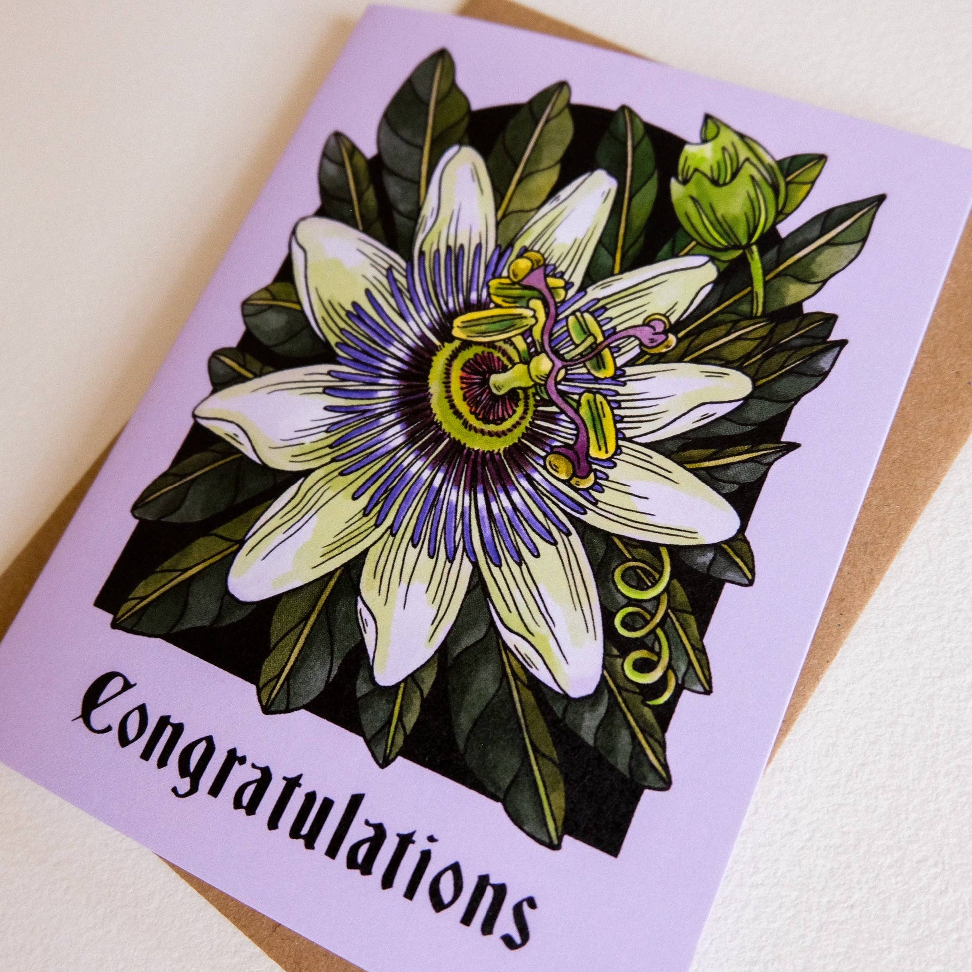Greeting card with aPassionflower design and 'Congratulations' text on a purple background.
