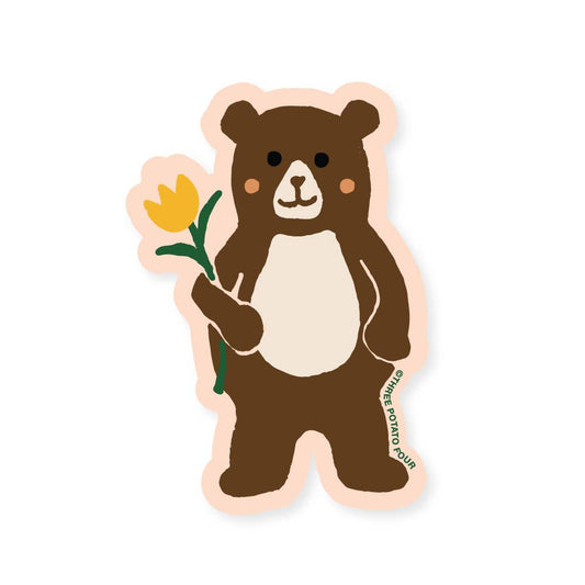Sticker of a bear holding a yellow flower on a white background