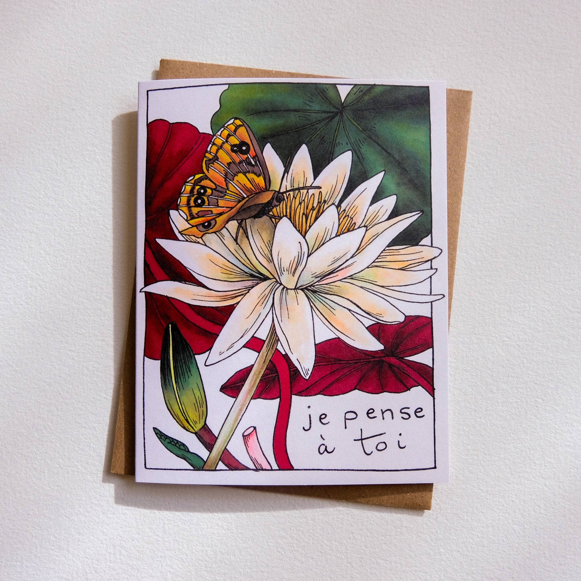 Greeting card with a butterfly on a flower and 'je pense à toi' text on a white background
