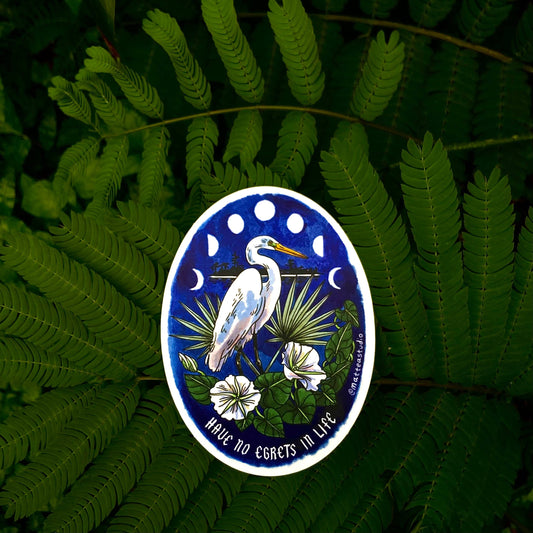 Decorative badge with a heron design on a fern leaf background