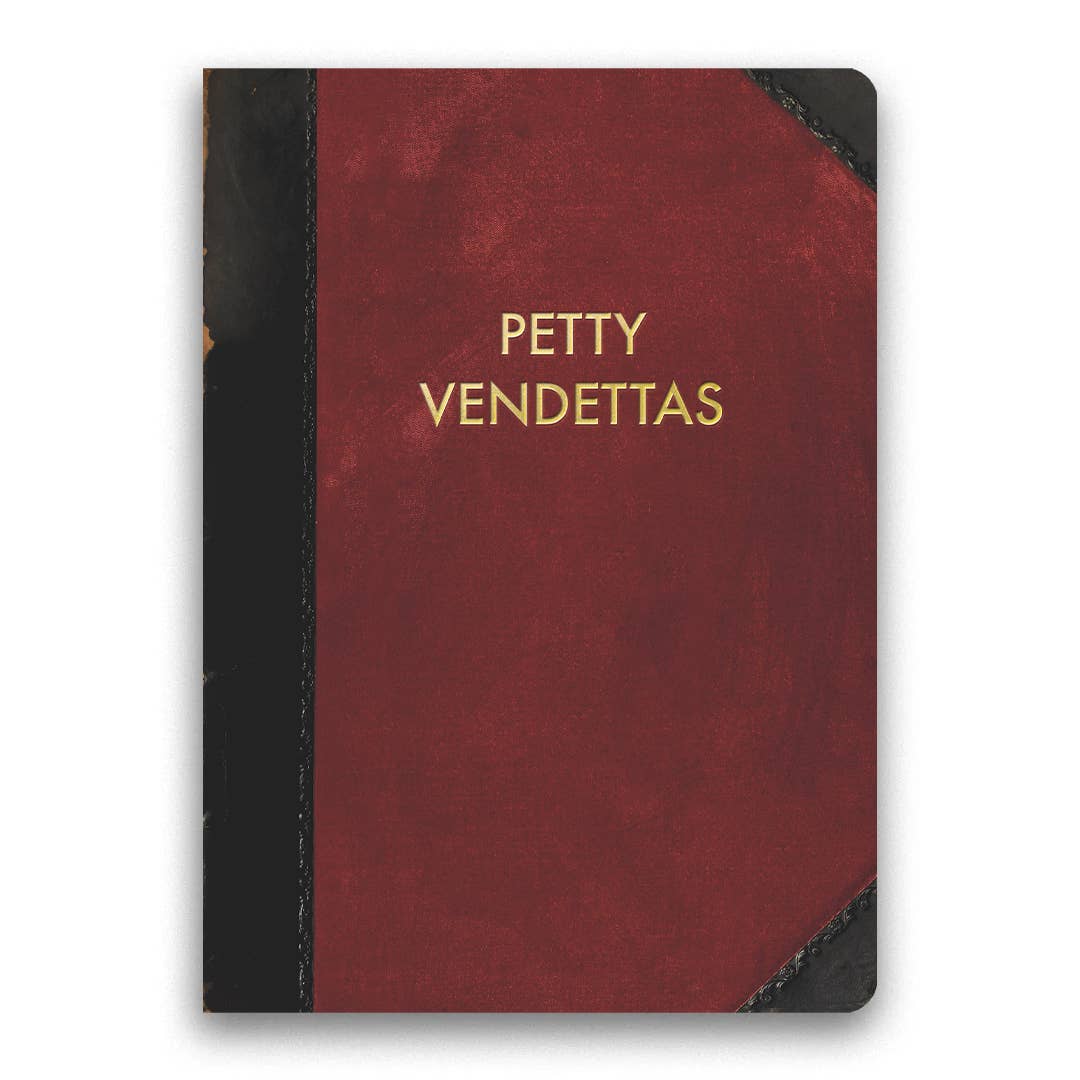 Red notebook with 'Petty Vendettas' in gold on a white background