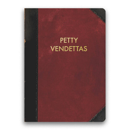 Red notebook with 'Petty Vendettas' in gold on a white background