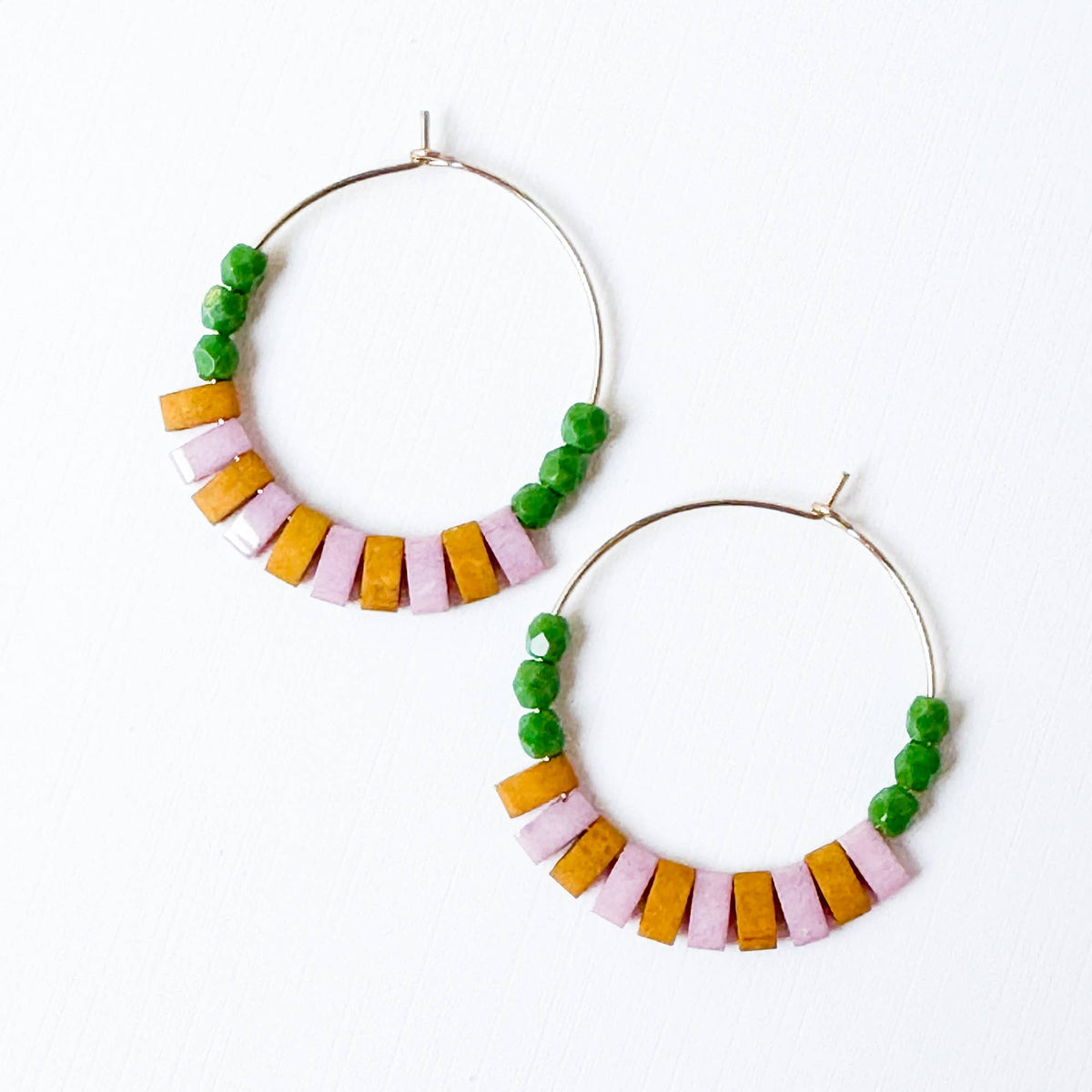 Pair of hoop earrings with colorful beads on a white background