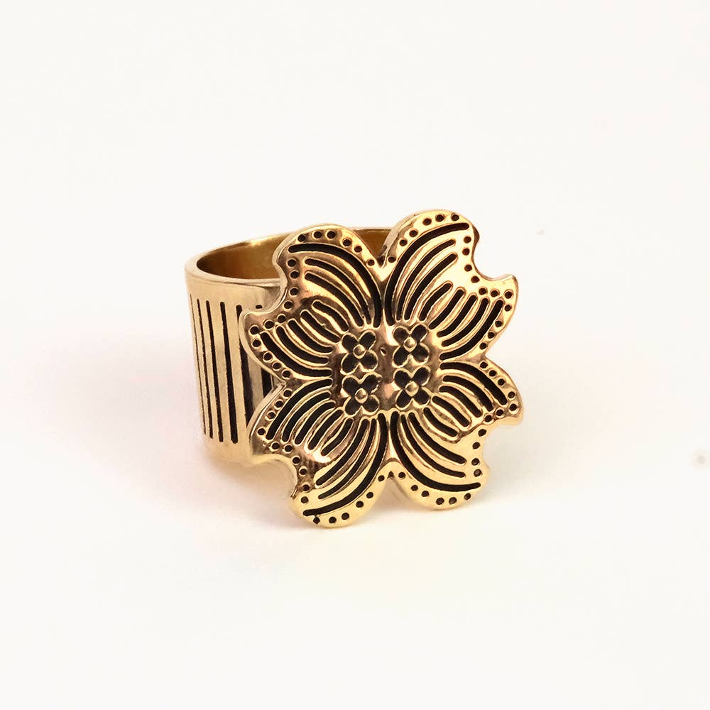 Gold floral ring on a white background