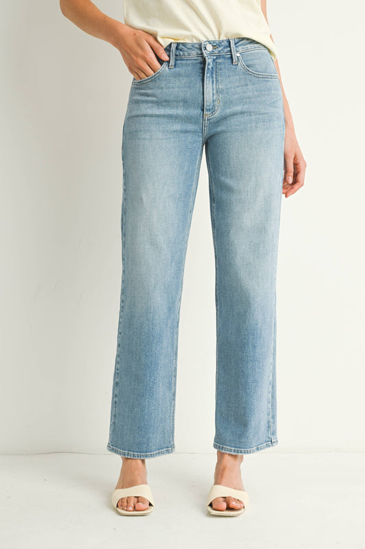 Light blue jeans worn by a person on a white background