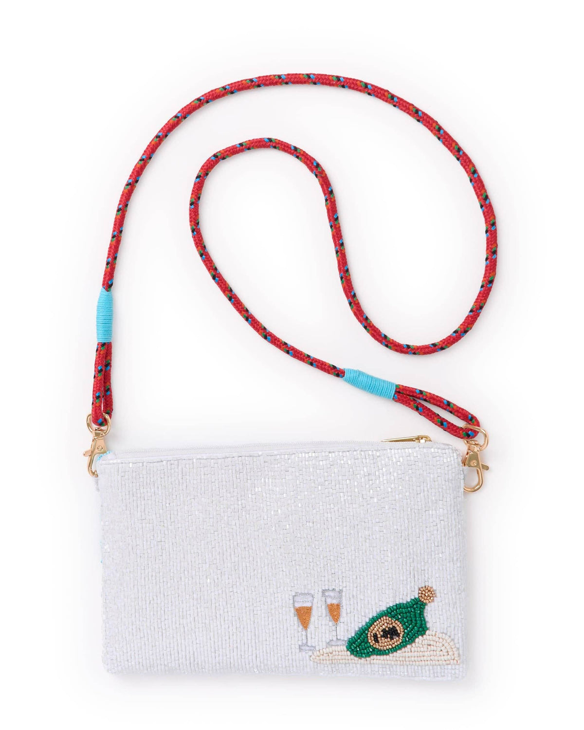 A white beaded clutch bag with a red patterned shoulder strap, featuring a green champagne bottle and two champagne glasses embroidered on the front, set against a plain white background.