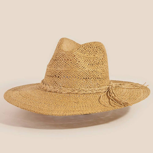 Woven straw hat with wide brim on a beige background