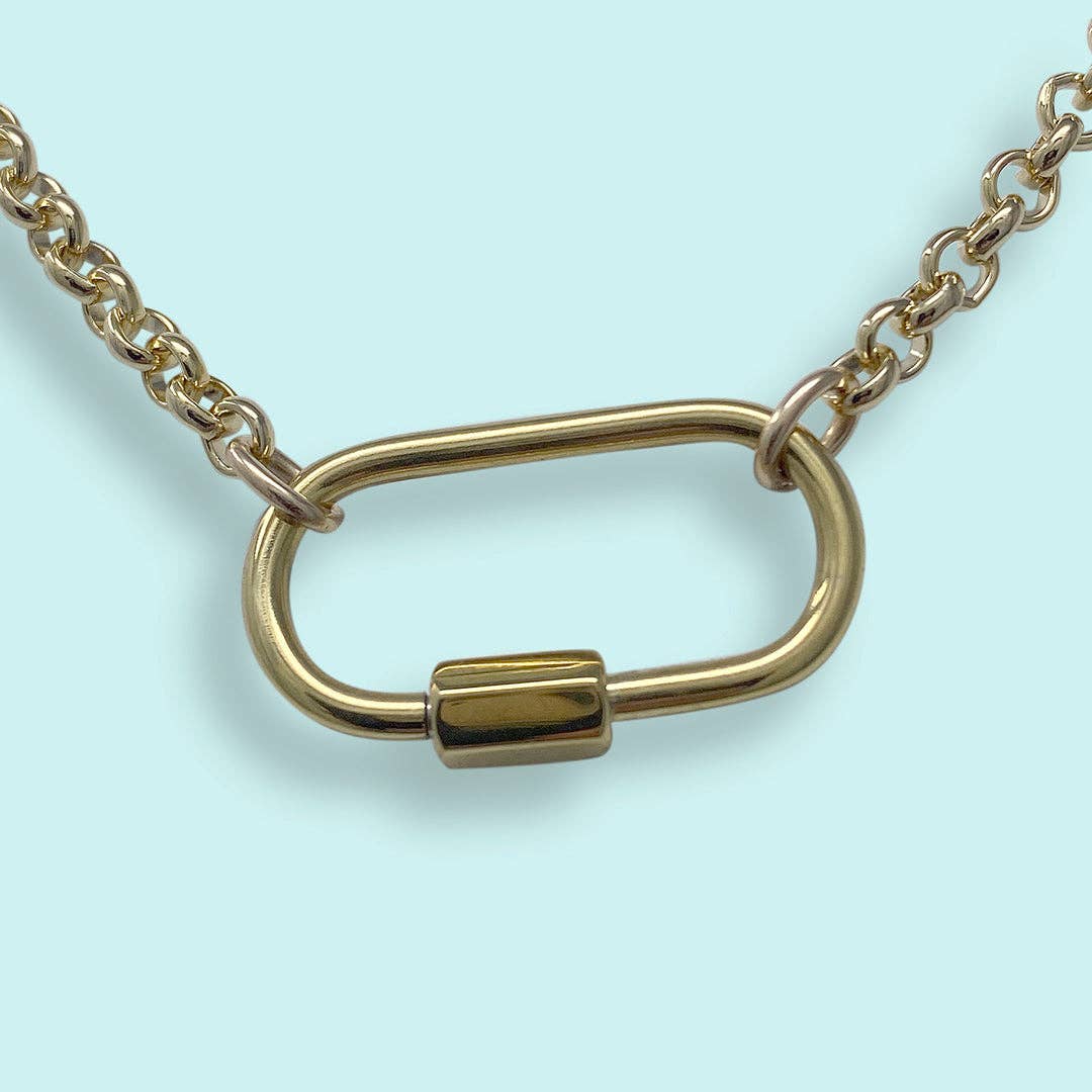 Gold chain with a unique clasp design on a light blue background