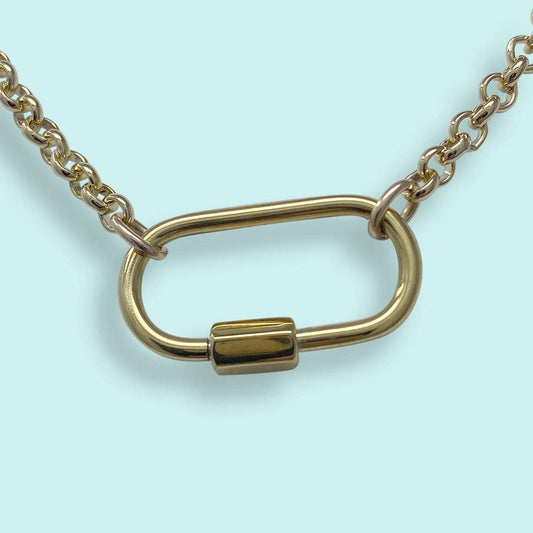 Gold chain with a unique clasp design on a light blue background