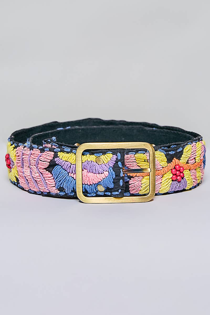 Dog collar with colorful floral embroidery and a gold buckle on a light gray background