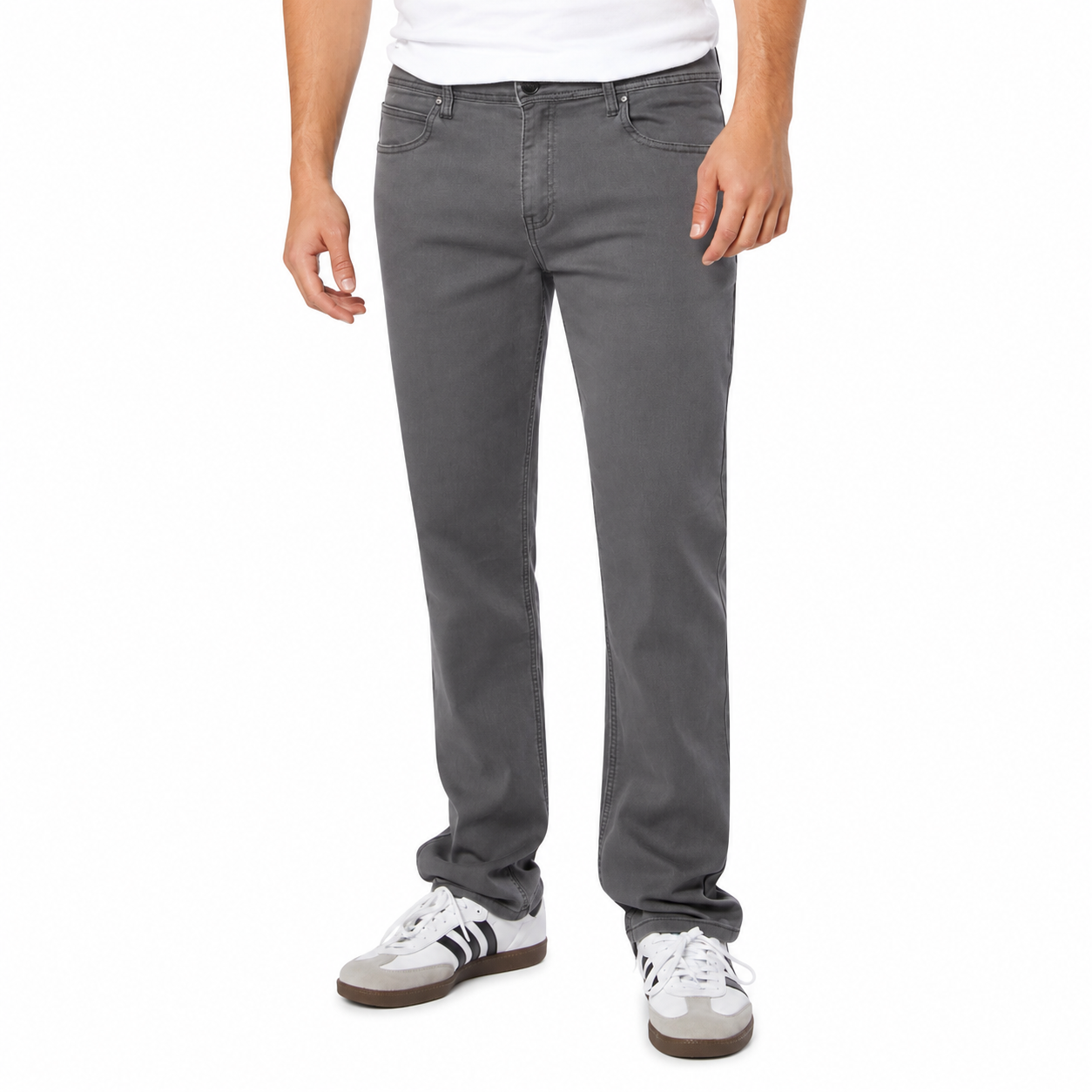 Person wearing gray jeans and white sneakers on a white background