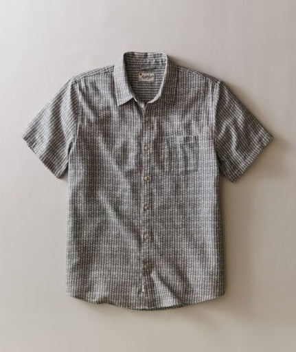 Short-sleeve checkered shirt on a beige background