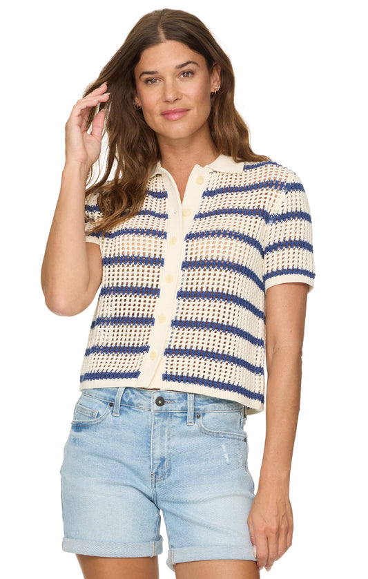 Woman wearing a striped shirt and denim shorts on a white background