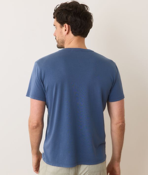 Man wearing a blue t-shirt against a plain background