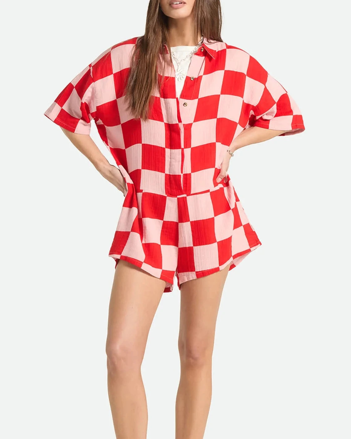 Woman wearing a red and white checkered dress on a white background